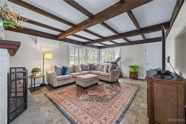 living room featuring beam ceiling, stone finish flooring, an AC wall unit, and baseboards