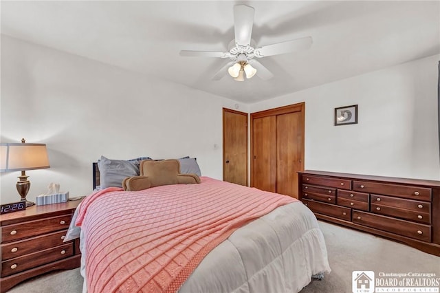 bedroom with ceiling fan and light carpet