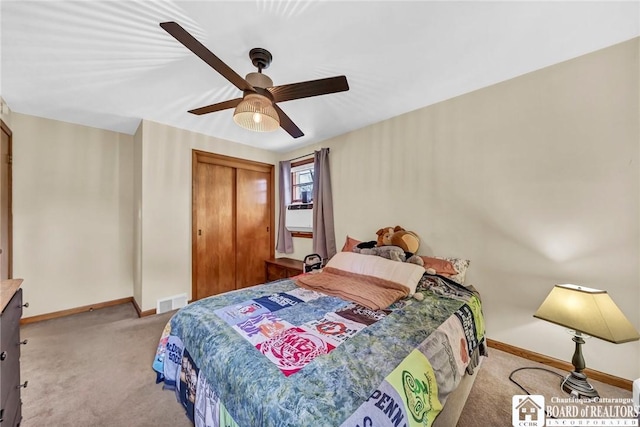 carpeted bedroom with baseboards, a ceiling fan, visible vents, and a closet
