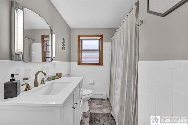 full bath with vanity, a baseboard radiator, toilet, and tile walls