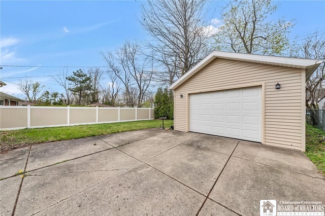 detached garage with fence and driveway