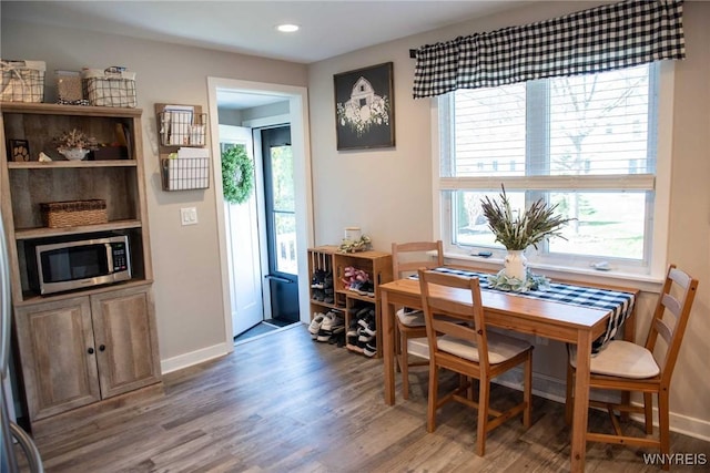 dining space featuring recessed lighting, baseboards, a wealth of natural light, and wood finished floors