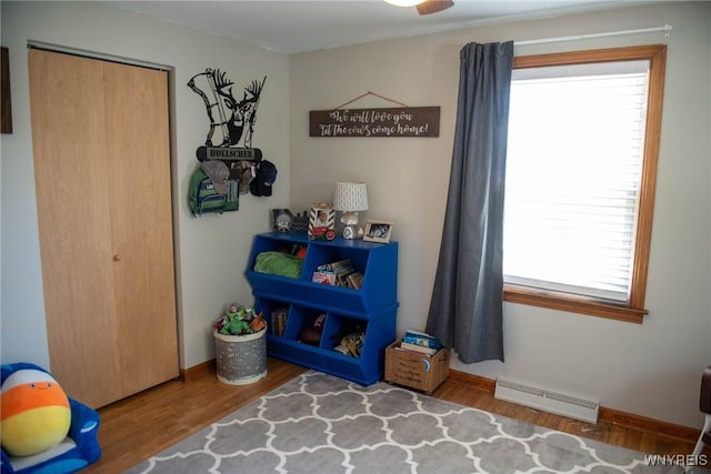 recreation room featuring visible vents, baseboards, and wood finished floors