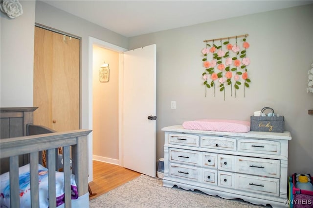 bedroom featuring a closet and light wood-type flooring