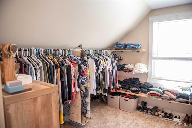 walk in closet featuring carpet flooring and lofted ceiling