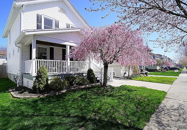 view of front of house with a front lawn and covered porch