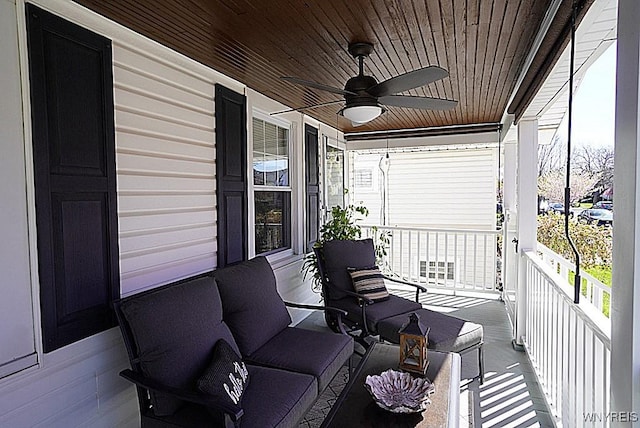 balcony with a porch and a ceiling fan