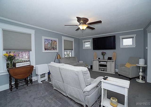 living area featuring baseboards, ornamental molding, a ceiling fan, and dark colored carpet