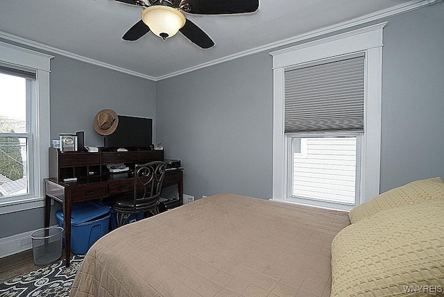 bedroom with crown molding, multiple windows, wood finished floors, and ceiling fan