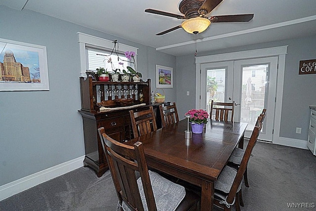 dining space with baseboards, plenty of natural light, french doors, and dark carpet