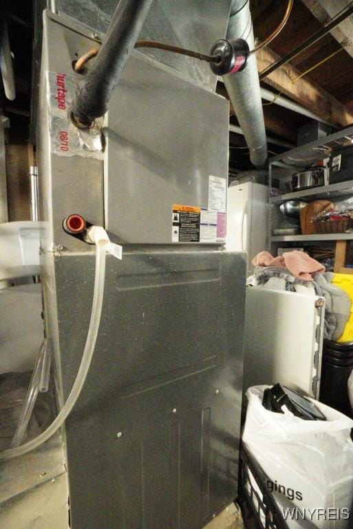 utility room featuring heating unit