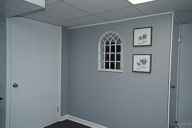 unfurnished room featuring baseboards and a paneled ceiling