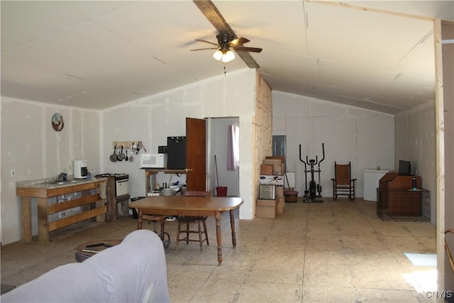 dining space with ceiling fan and vaulted ceiling