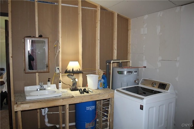 laundry area with water heater, washer / clothes dryer, laundry area, and a sink