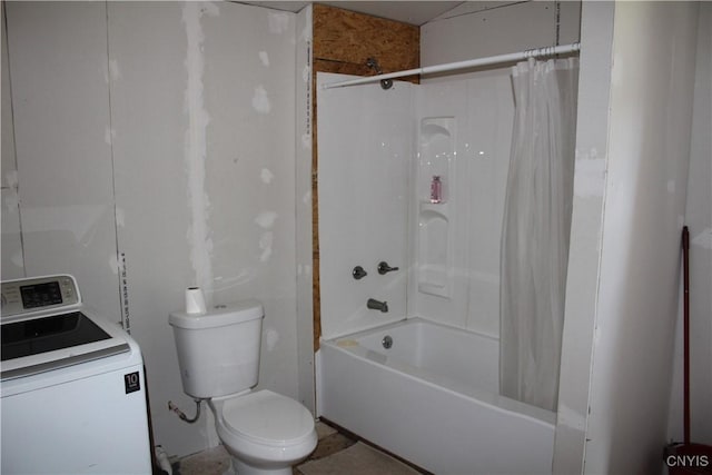 bathroom with toilet, washer / dryer, and shower / bath combo