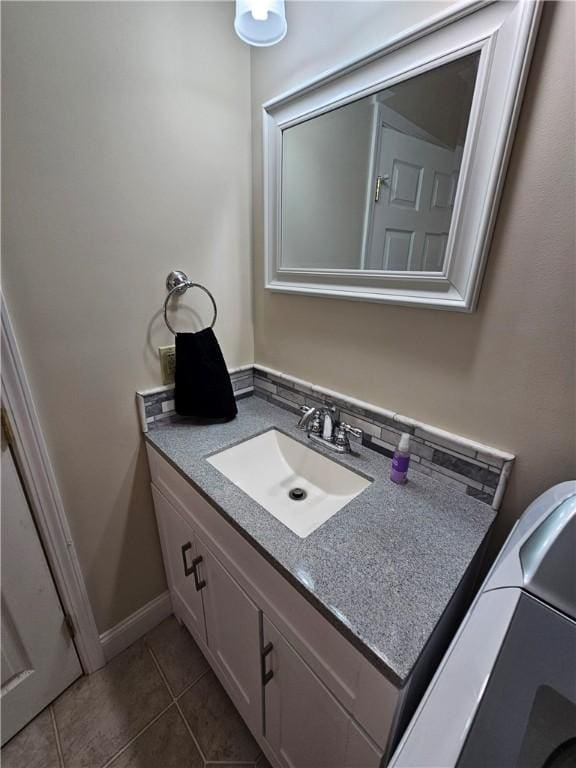 bathroom featuring tile patterned flooring and vanity