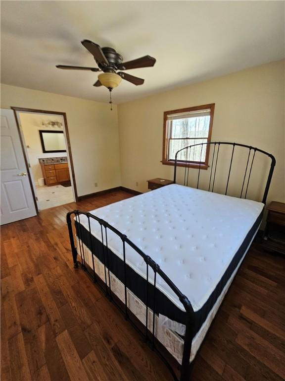 bedroom with a ceiling fan, wood finished floors, and ensuite bathroom