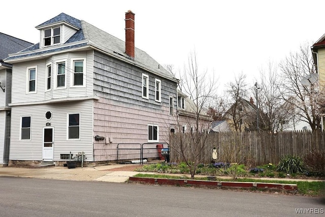 view of property exterior with a chimney