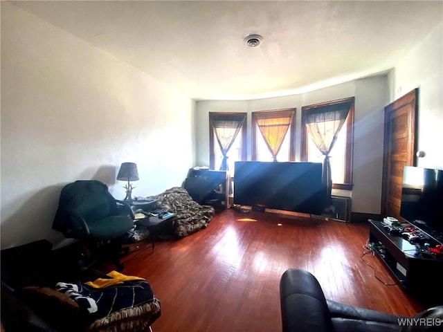 living room featuring visible vents and wood finished floors