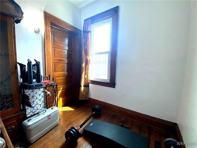 interior space with wood finished floors and baseboards