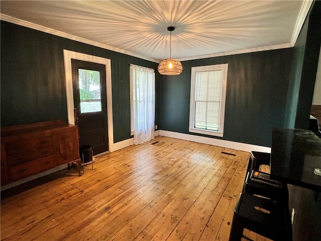 interior space featuring ornamental molding and hardwood / wood-style flooring