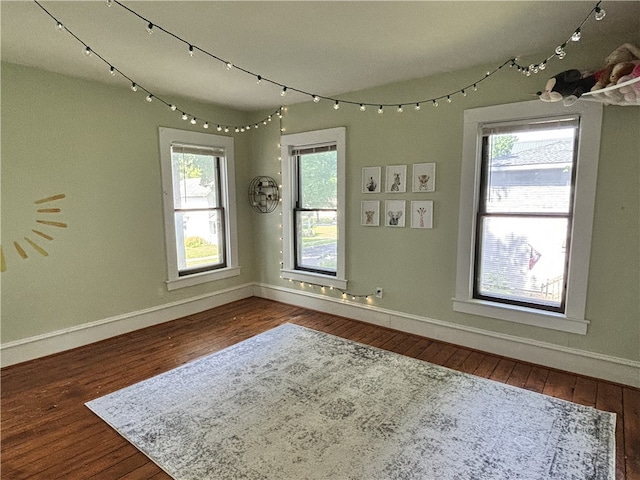 empty room with wood finished floors and baseboards
