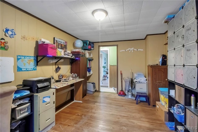 office with crown molding and light wood-style floors