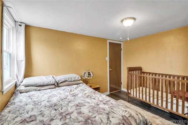 bedroom with baseboards and wood finished floors