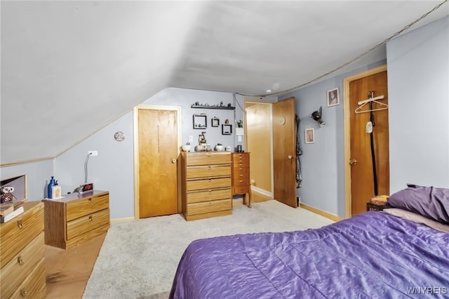bedroom featuring baseboards, vaulted ceiling, and light carpet