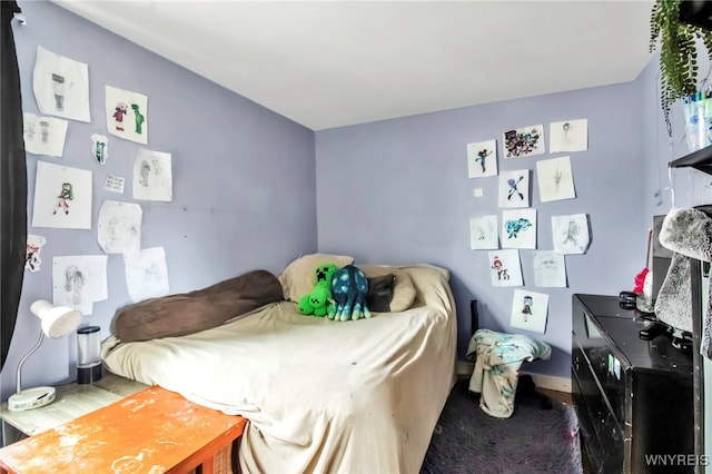 carpeted bedroom featuring baseboards