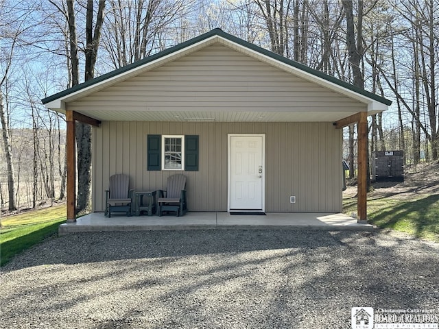 view of outdoor structure featuring covered porch