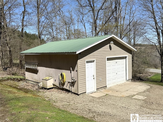 detached garage featuring driveway