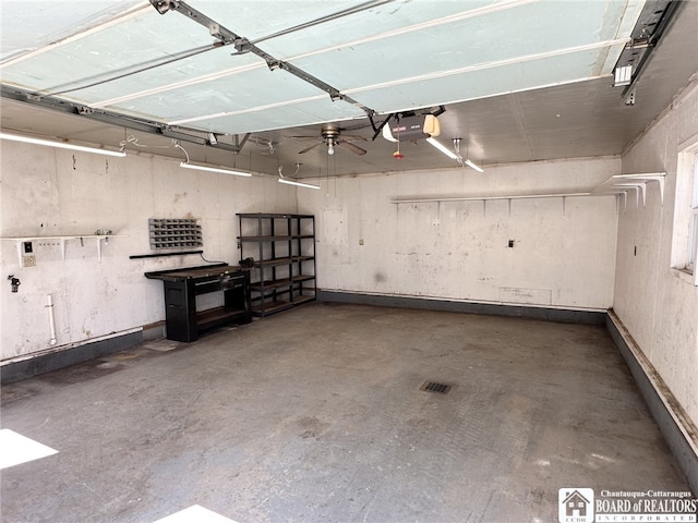 garage featuring a workshop area, a ceiling fan, and a garage door opener