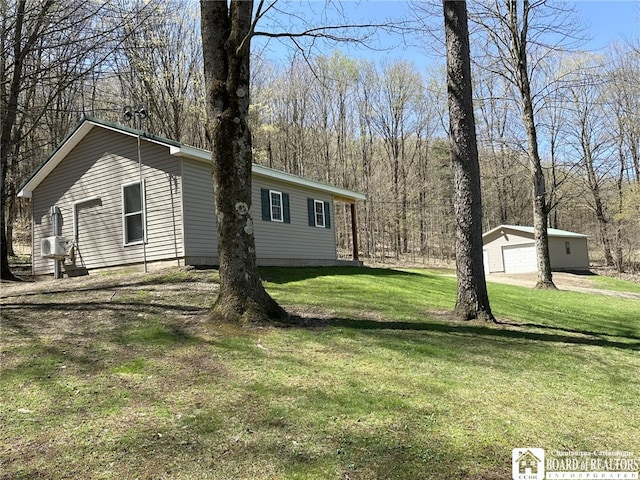 exterior space with a detached garage and an outbuilding