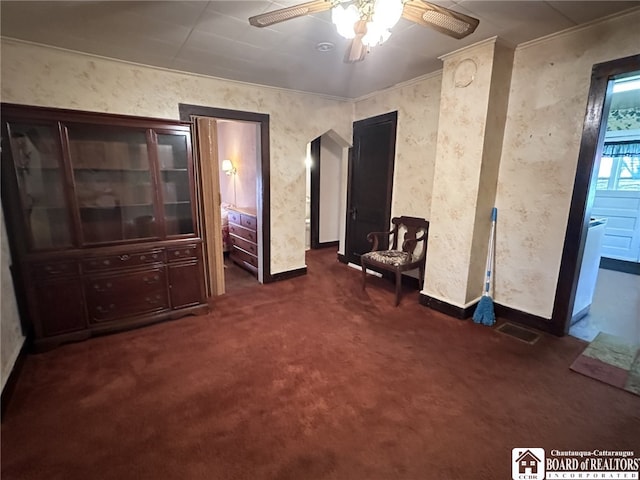 interior space with carpet, ceiling fan, visible vents, and baseboards