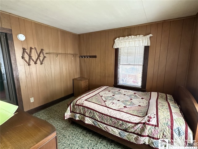 bedroom featuring wooden walls and carpet floors
