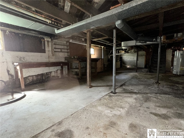 unfinished below grade area featuring water heater