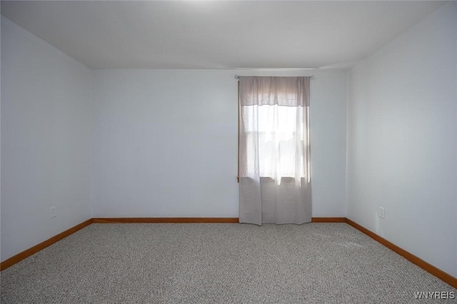 carpeted spare room with baseboards