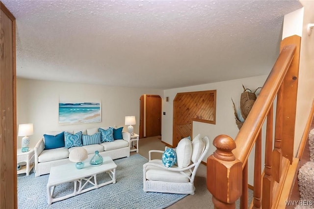 living room with a textured ceiling, carpet, and arched walkways