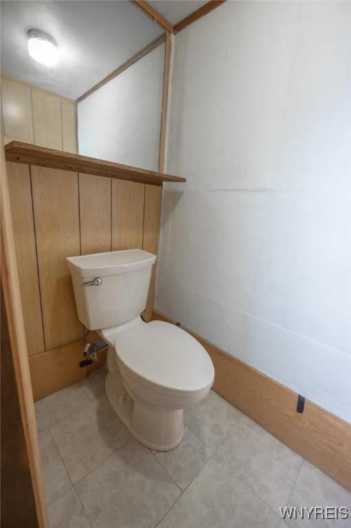 bathroom featuring toilet and tile patterned flooring
