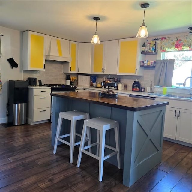 520 Logan St, Elmira-City, NY 14901 - kitchen with custom range hood, wood counters, tasteful backsplash, a kitchen island, and dark wood finished floors
