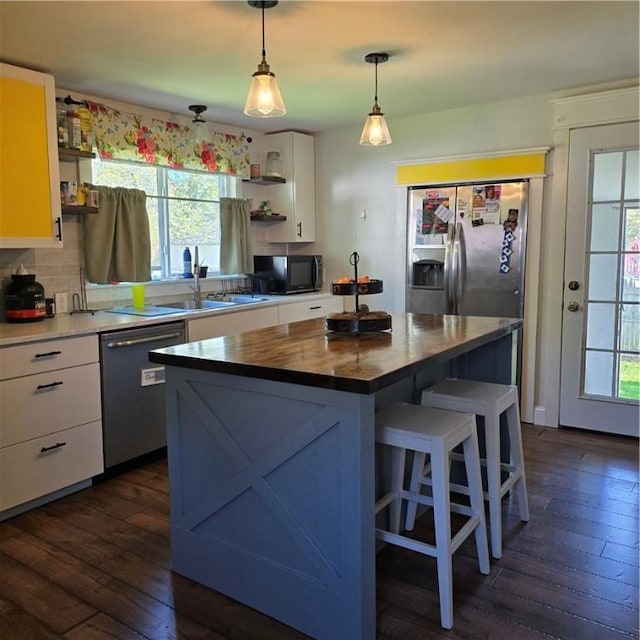 520 Logan St, Elmira-City, NY 14901 - kitchen with stainless steel appliances, open shelves, dark wood finished floors, white cabinetry, and a kitchen island
