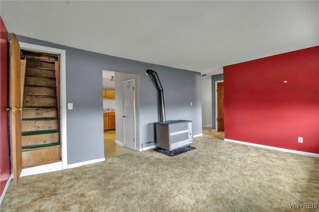 unfurnished living room featuring carpet flooring and baseboards