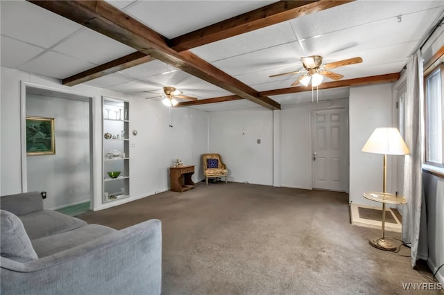 living area featuring a ceiling fan, beam ceiling, carpet, and baseboards