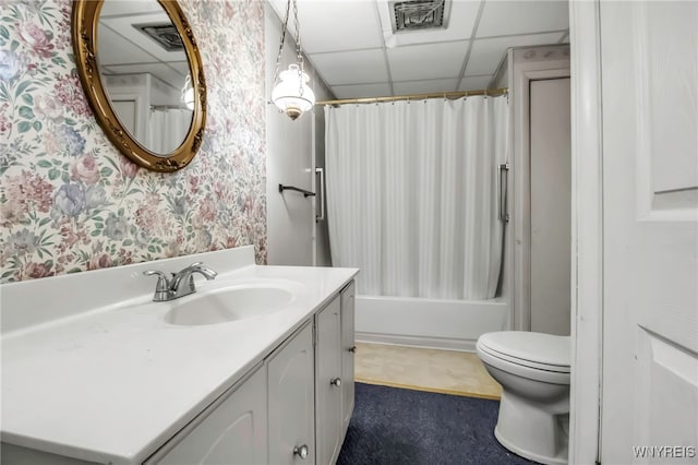 full bath with wallpapered walls, toilet, vanity, visible vents, and a paneled ceiling