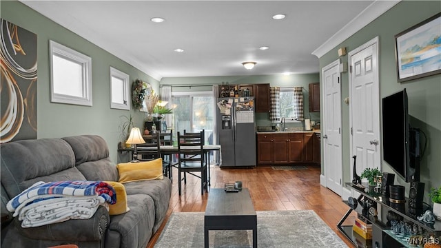 living area with recessed lighting, ornamental molding, and hardwood / wood-style floors