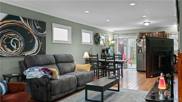 living room featuring wood-type flooring and recessed lighting