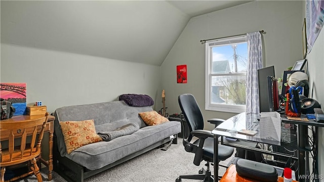 carpeted office featuring lofted ceiling