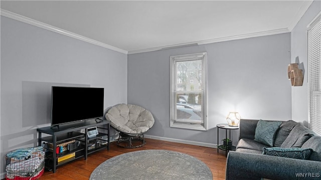 living room featuring baseboards, ornamental molding, and wood finished floors