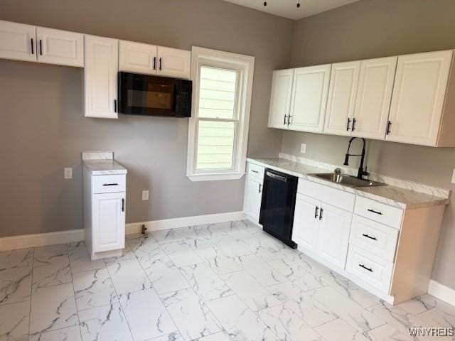 kitchen with marble finish floor, white cabinets, black appliances, a sink, and baseboards